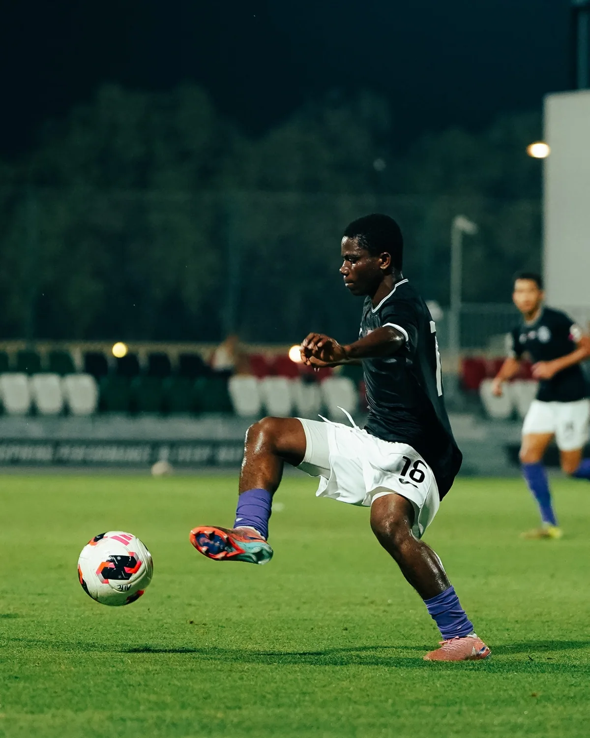 FC Athletica player competing in a football match